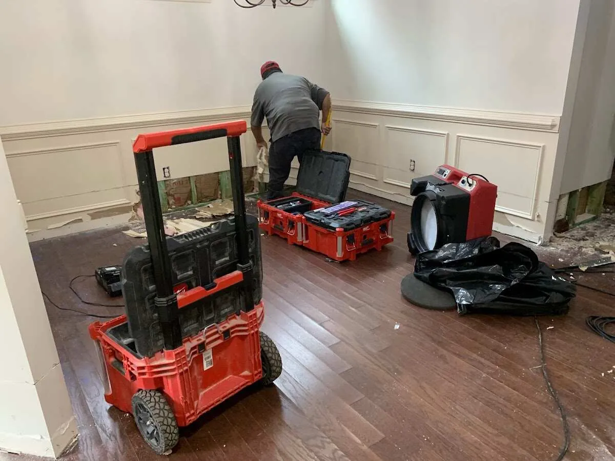 Technician setting up drying equipment for water damage in Midway